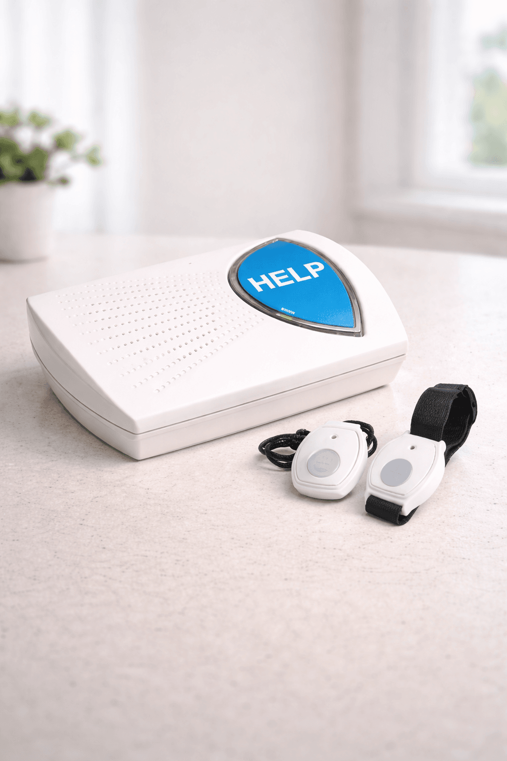 Indy at Home base station and waterproof pendant button on a kitchen counter, soft natural light from a nearby window