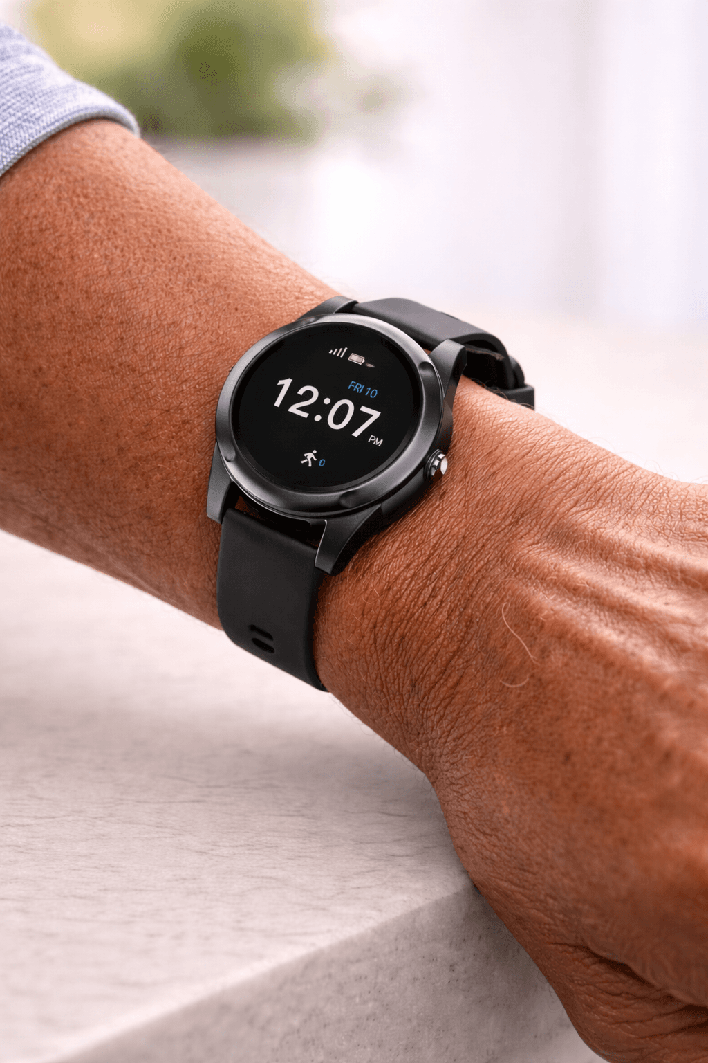 Indy Smartwatch worn on a senior man's wrist while he reads in a comfortable armchair, close-up showing the modern watch face