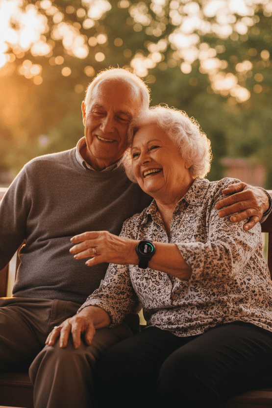 Elderly couple sitting together on a porch swing, the woman wearing an Indy Smartwatch on her wrist, golden hour sunlight, relaxed and happy
